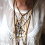 Fine vintage chain and black bugle bead spider web bib necklace on model.