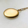 Plain matte gold-shell round Victorian locket necklace