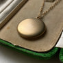 Plain matte gold-shell round Victorian locket necklace