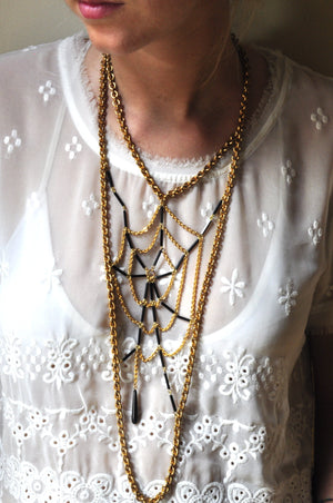 Fine vintage chain and black bugle bead spider web bib necklace on model.